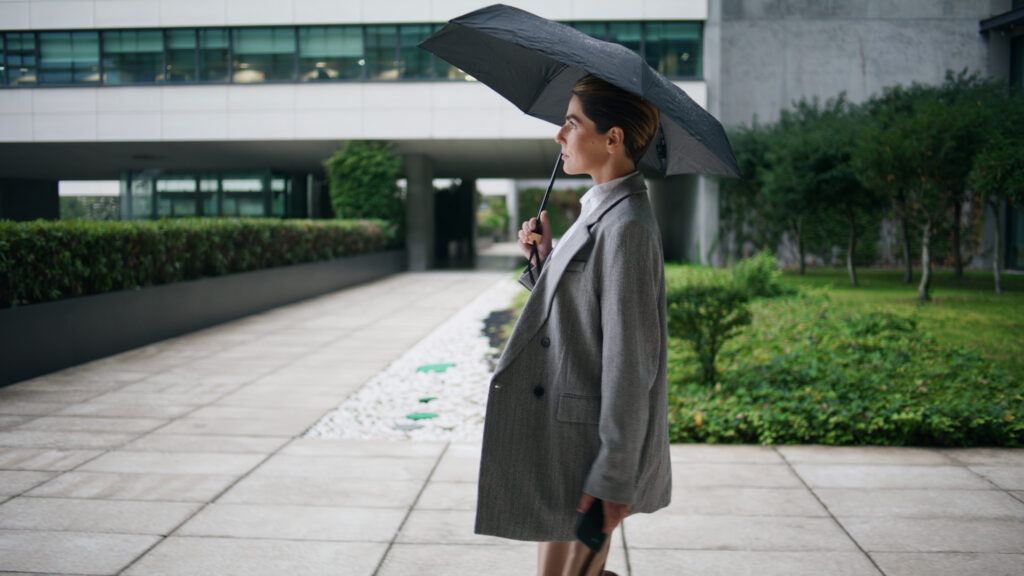 business woman walking with an umbrella