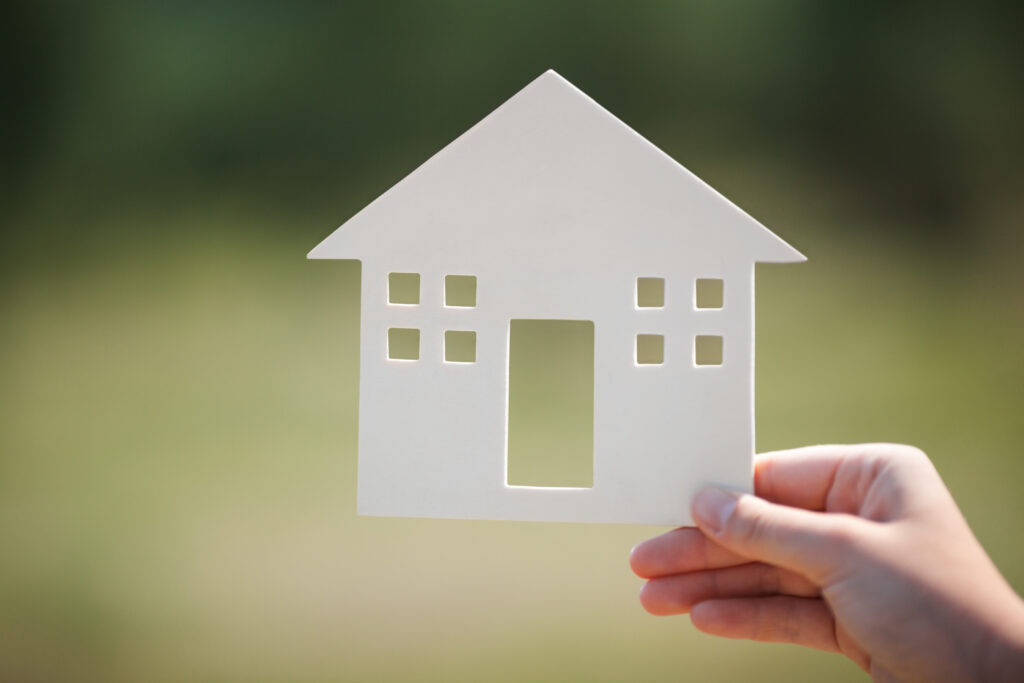 Hand holding a house model