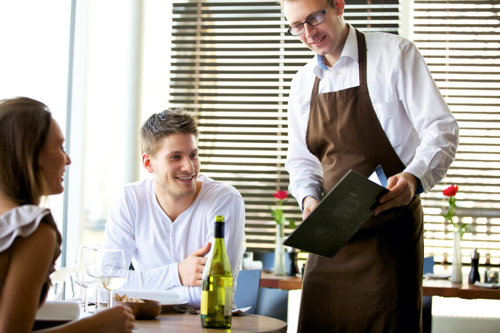 couple being serviced in a restaurant