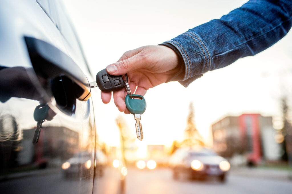 Woman opening her car door with a a key